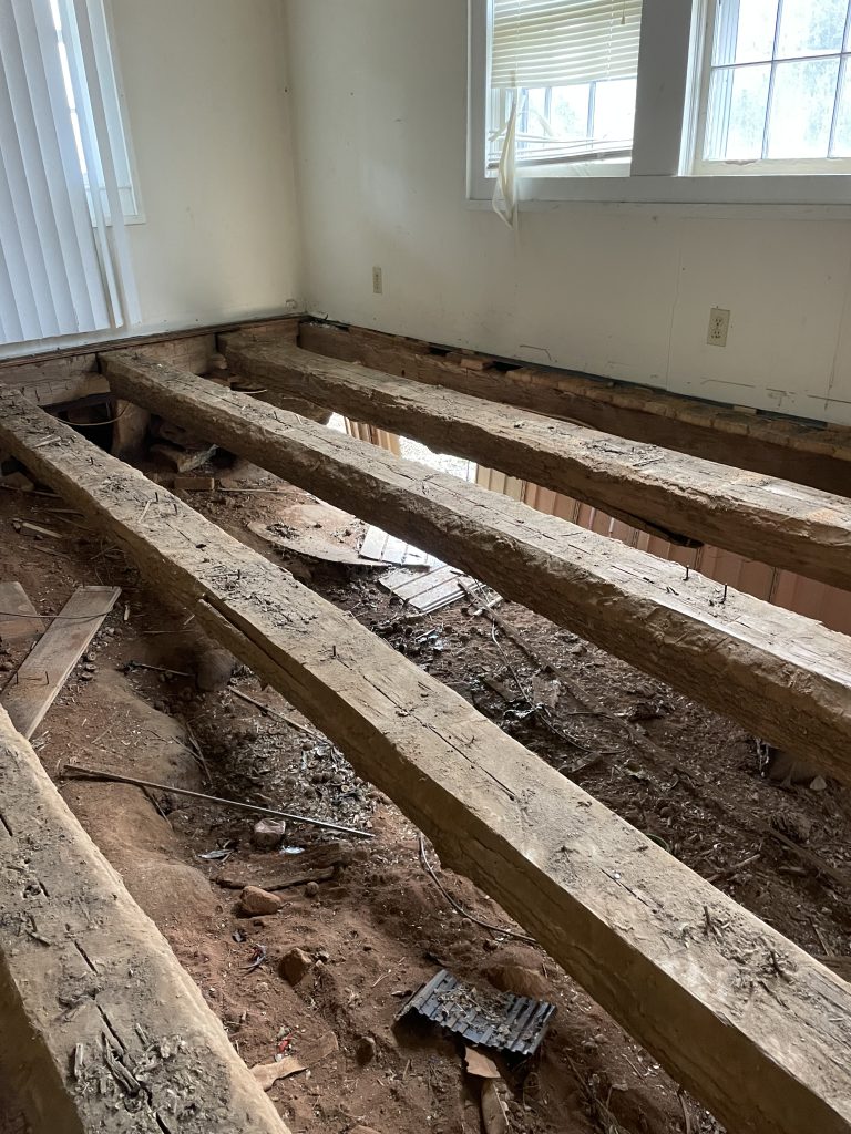 Hand hewn logs as used as floor joists on an old upstate SC home.