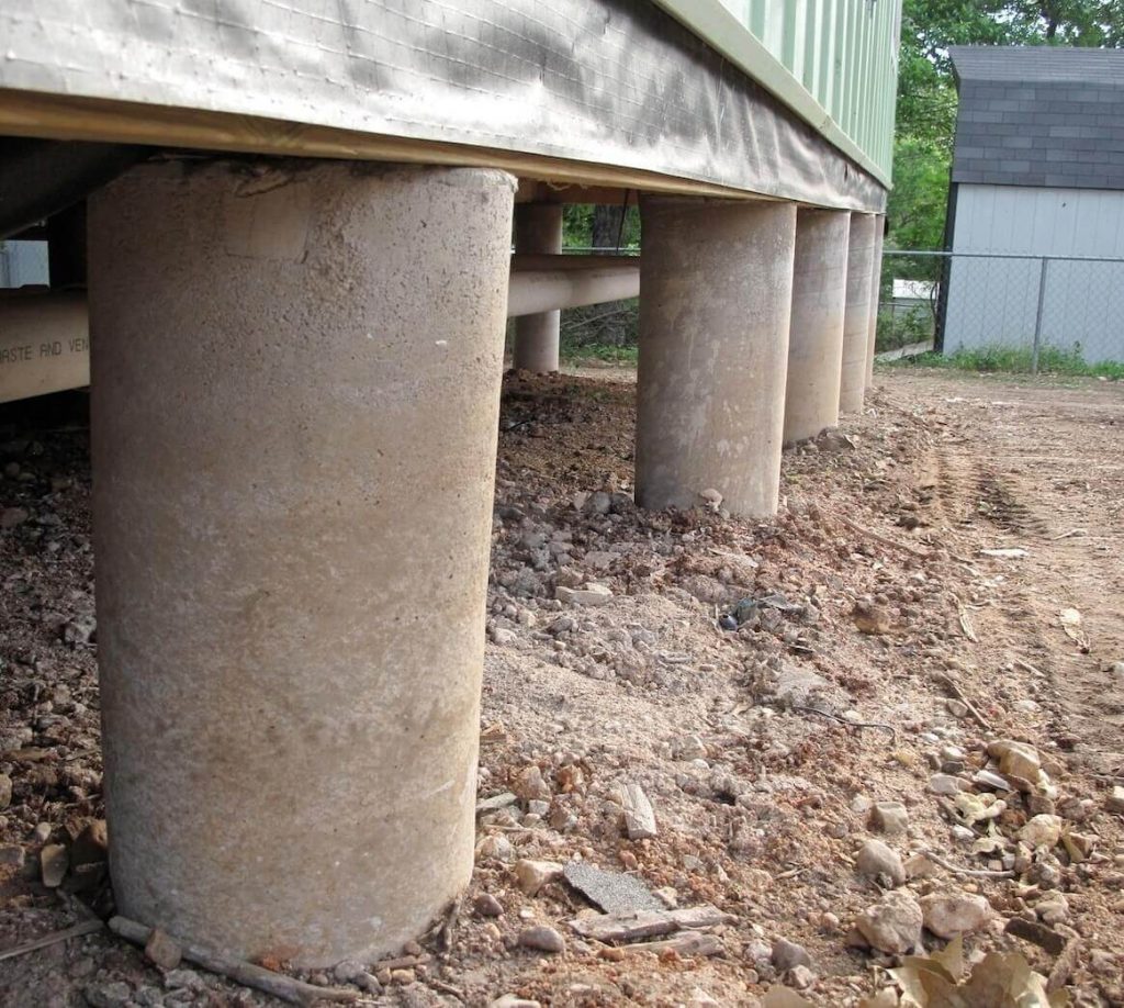 Poured concrete pier and beam foundation.